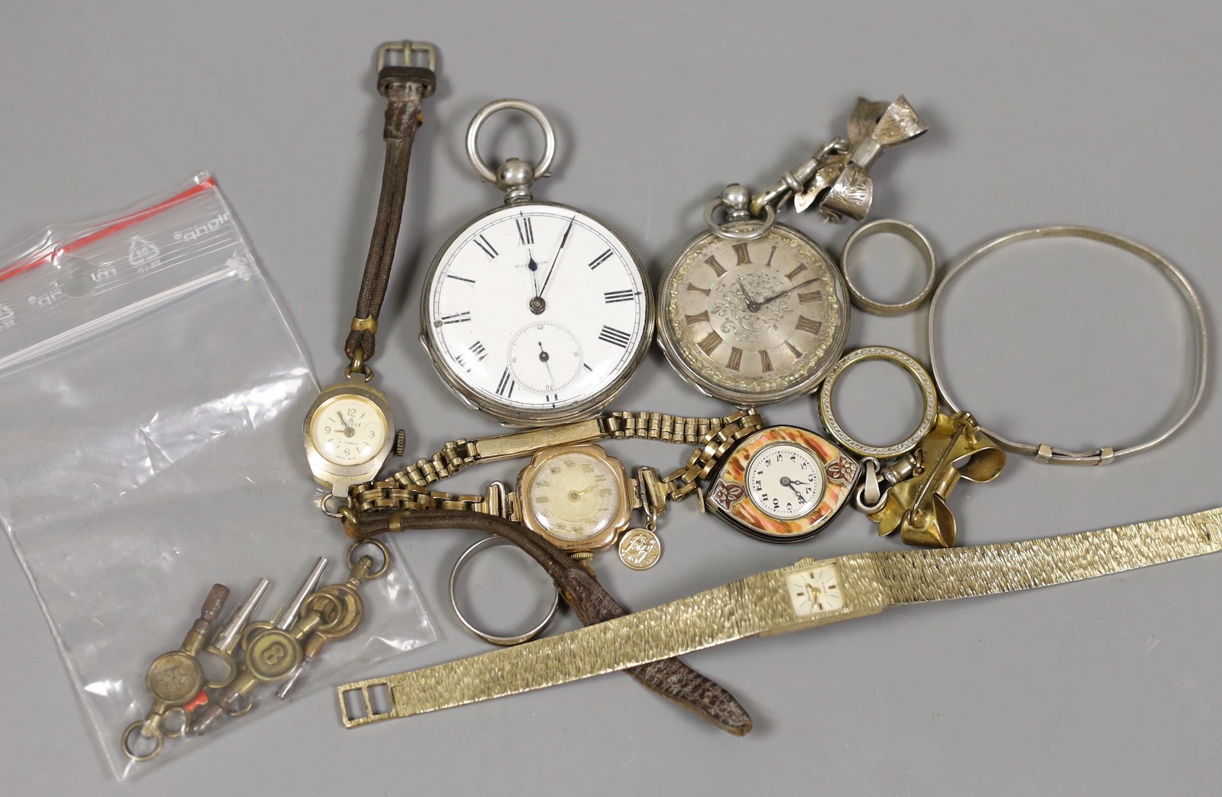 Sundry watches and jewellery including a white metal open face pocket watch and fob watch, three lady's wrist watches including one 9ct gold cased, three costume rings, a bangle, assorted watch keys and a lady's enamelle